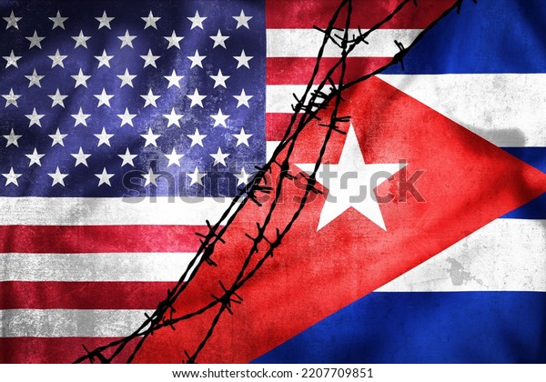 Grunge flags of USA\
and Cuba divided by barb wire illustration, concept of tense\
relations between USA and Cuba\
