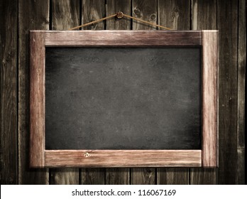 Grunge small blackboard hanging on wooden wall as a background for your message - Powered by Shutterstock