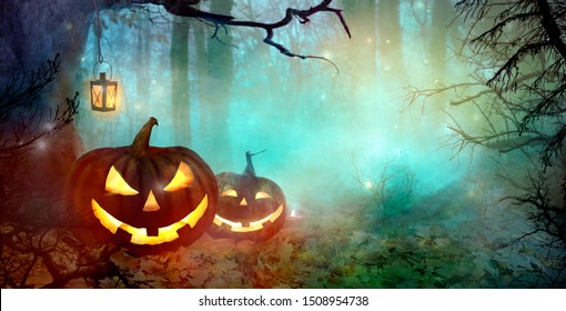 Halloween Background. Scary Pumpkins And Dark Forest. Halloween backdrop with Jack O' Lantern