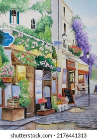 Hand Drawn Watercolor Painting Of Beautiful Shops. Landmark Painting With Flower Shop,street,cafe, Restaurant, Wet Paved Walkway, Plants, Flowers,menu Board, Window Display,wall And Lamp For Print,etc