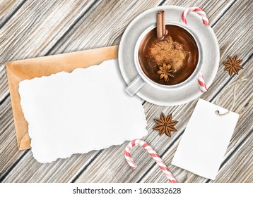 Hand Drawn Winter Rustic Mock-up Scene. Blank Cotton Paper Greeting Card, Brown Wooden Background, Envelope, Hot Chocolate, Tag, Candy Cane, Anise. Top View.