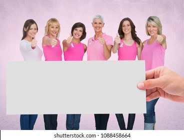 Hand holding card with pink breast cancer awareness women - Powered by Shutterstock