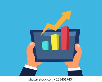 Hand holding tablet with analyzing graph. Trading chart. Stock market and forex currency trading concept. Chart showing upward trend of market.