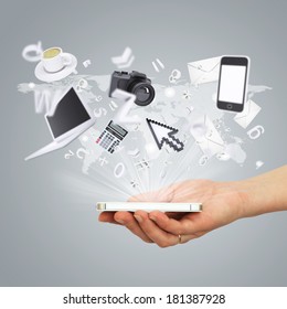 Hand holding tablet pc. Electronics are emitted from the screen tablet. The concept of electronics