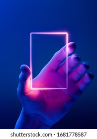 Hand Holding Vertical Neon Frame. Hand Illuminated by Pink, Violet and Blue Neon Lights. 3d rendering