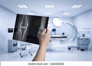 Hand holding x-ray film with 3d rendering mri scan machine or magnetic resonance imaging scan device