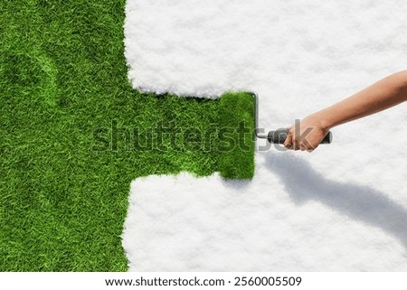 Hand using paint roller to cover white snow with vibrant green grass, symbolizing transition from winter to spring, renewal and environmental concepts. 3d rendering