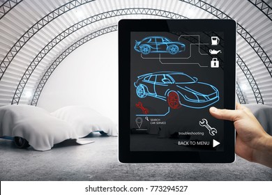 Hand using tablet with car service interface. Garage in the background. Auto mechanic and maintenance concept. 3D Rendering 