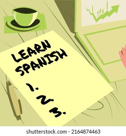 Hand Writing Sign Learn Spanish. Internet Concept Translation Language In Spain Vocabulary Dialect Speech Laptop Resting Beside Coffee Mug And Plain Sheet Showing Work Process.