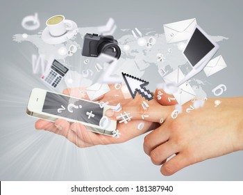 Hands holding tablet pc. Electronics are emitted from the screen tablet. The concept of electronics