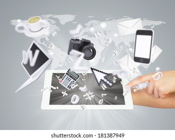 Hands holding tablet pc. Electronics are emitted from the screen tablet. The concept of electronics
