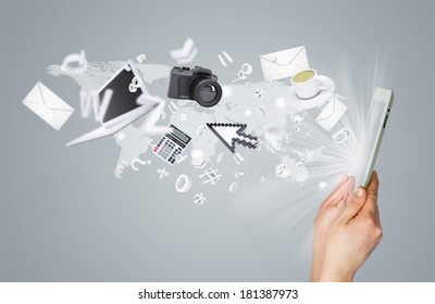 Hands holding tablet pc. Electronics are emitted from the screen tablet. The concept of electronics