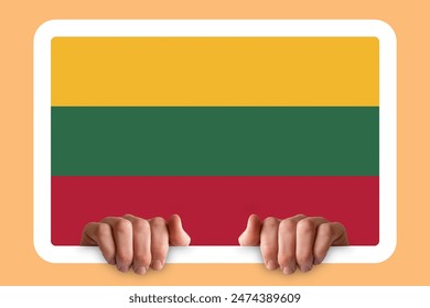 Hands holding a white frame with Lithuania flag, protest or social issues in Lithuania, independence day idea, two hands and frame, celebration or campaigning concept - Powered by Shutterstock