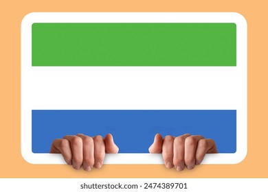 Hands holding a white frame with Sierra Leone flag, celebration or campaigning concept, two hands and frame, protest or social issues in Sierra Leone, independence day idea - Powered by Shutterstock