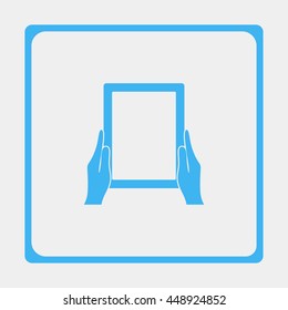 Hands holing tablet computer with blank screen.