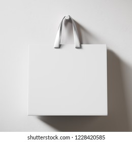 Hanging White Shopping Bag Isolated On Bright Background. Mock Up. 3d Rendering