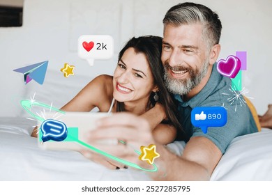 Happy couple taking a selfie together surrounded by social media icons, showcasing love and engagement in a fun and social media lifestyle. Couple selfie on the bed and social media icons around - Powered by Shutterstock