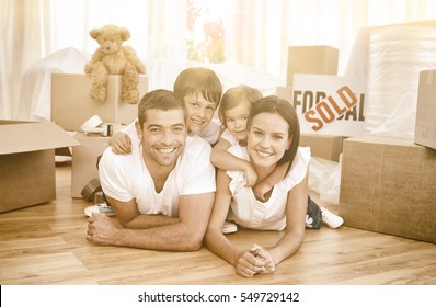 Happy family lying on floor after buying new house - Powered by Shutterstock