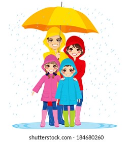 Happy Family With Raincoats Under Big Umbrella On Rainy Day