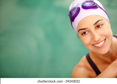 Happy female swimmer wearing a hat and goggles - Powered by Shutterstock