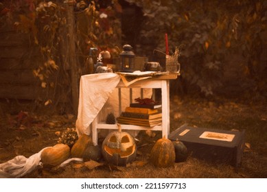 Happy Halloween Carving Pumpkin On The Table In The Garden. Happy Family Preparing For Halloween. Background Photo