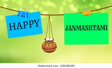 Happy Janmashtmi Letter On Paper Card On Blur Green Background. Pot For Janmashtmi Sigh.