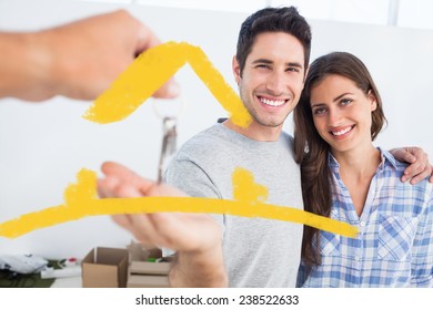 Happy man being given a house key against house outline - Powered by Shutterstock