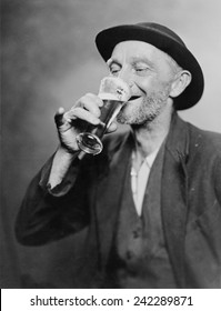 Happy Old Man Drinking Glass Of Beer, With His Daintier Finger Extended. 1937.