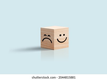 happy and sad Face In Wooden Cube Business concept. Blue background. Positive negative feedback, customer review, optimist pessimist character . 3d illustration