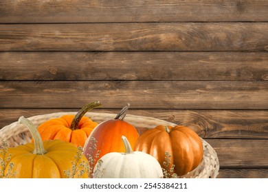 Happy Thanksgiving Concept with a Basket of Pumpkins in Holiday Season Autumn with Rustic Wood Background - Powered by Shutterstock