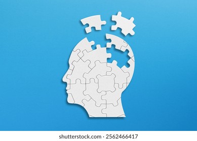Head and brain diseases concept. A missing pieces of the brain puzzle on blue background.