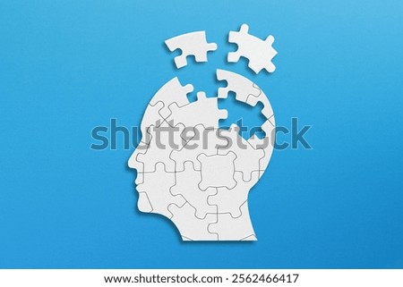 Head and brain diseases concept. A missing pieces of the brain puzzle on blue background.