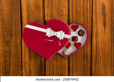 Heart Shaped Box Of Candy Against Overhead Of Wooden Planks