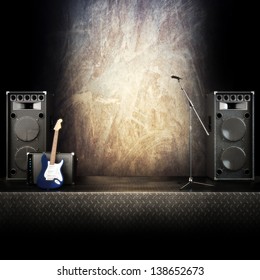 Heavy Metal Music Stage Or Singing Background, Microphone, Electric Guitar And Speakers With Diamond Plated Flooring. Advertising Concept With Room For Text Or Copy Space