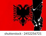 Helping hand against the Albania flag. The concept of support. Two hands taking each other. A helping hand for those injured in the fighting, lend a hand