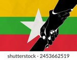 Helping hand against the Myanmar flag. The concept of support. Two hands taking each other. A helping hand for those injured in the fighting, lend a hand