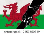 Helping hand against the Wales flag. The concept of support. Two hands taking each other. A helping hand for those injured in the fighting, lend a hand