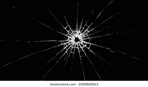 A highcontrast image shows a shattered piece of glass with radial cracks emanating from a central point against a black background. The cracks are bright white, creating a starburst effect.