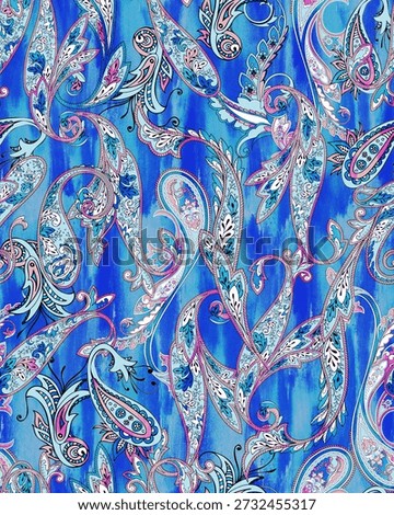 High-quality seamless paisley pattern featuring intricate floral ornaments and swirls in vibrant shades of blue, pink, and magenta. The design is layered over a dynamic blue watercolor wash texture, making it perfect for boho-style fashion textiles, artistic wallpaper, decorative home accessories, and creative digital backgrounds.