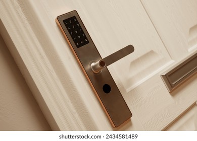 A high-resolution shot capturing the sleek digital keypad of a lock system affixed to a polished wooden door, epitomizing modern home security sophistication.