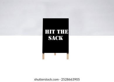 HIT THE SACK. A-Frame Sign. Sidewalk chalk board. Advertising sign. Old Black Chalk board. Store signage. Black board advertising sign. Common Sayings. Good Advice. Hit the sack. Going to the gym.  - Powered by Shutterstock