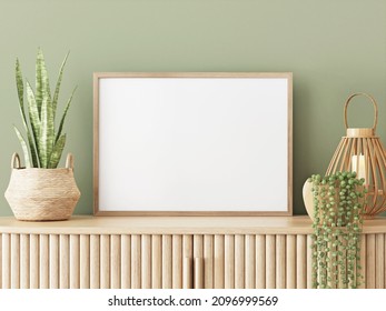 Horizontal blank frame mockup in living interior with slat sideboard, wicker lantern and plant in basket on empty green wall background. 3D rendering, illustration