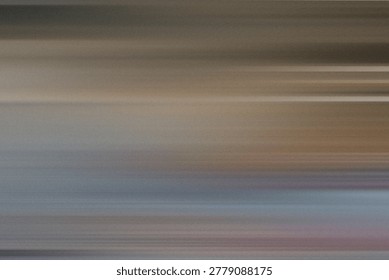 A horizontal motion blur texture showcasing a blend of muted brown, grey, and soft blue hues, evoking a sense of movement and natural serenity.