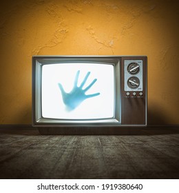 Horror scary movie concept. Hand of ghost on screen of vintage tv in haunted house. 3d illustration