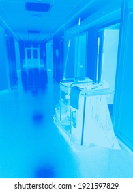 Hospital Corridor With A Trolley With Accessories For Cleaning And Washing The Premises In The Ultraviolet Light Of Disinfecting Lamps To Clean The Space From Viruses And Microbes,