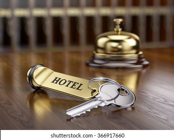 Hotel key and reception bell on reception desk