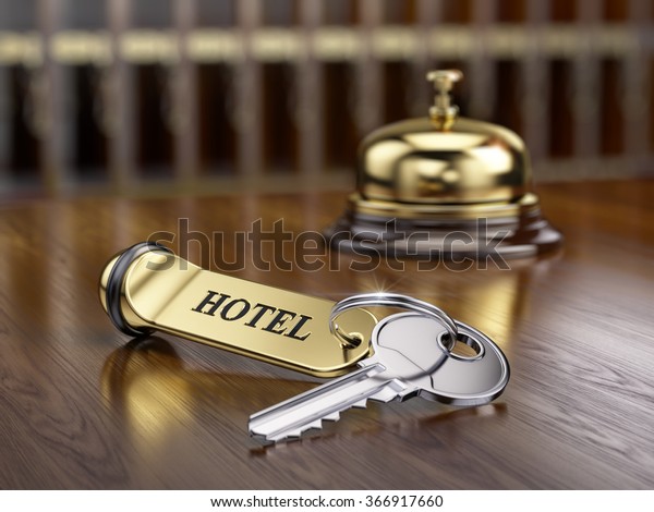 Hotel key and\
reception bell on reception\
desk