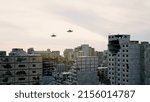 Huge damage cause by the war in Ukraine. The ruined city landmarks, debris of buildings, smoldering parts of Mariupol city structures. Fighting tanks drive through the occupied city, helicopters fly