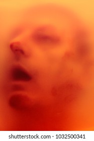 human face behind semitransparent screen