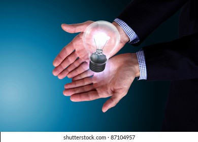 Human hand holding a shining electric bulb - Shutterstock ID 87104957